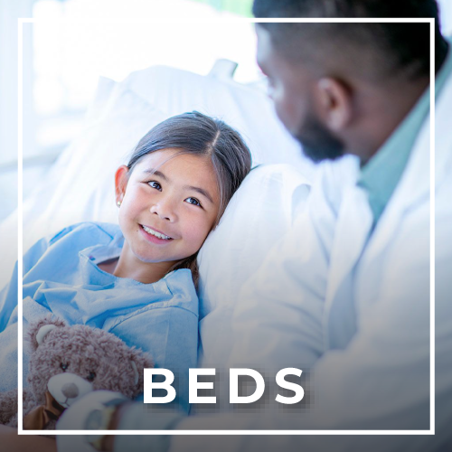 Asian girl on hospital bed being taken care of with teddy bear